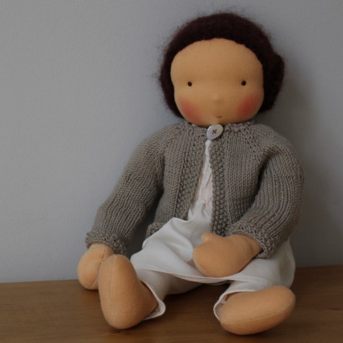 Waldorf doll girl in white dress and beige cardigan, dark brown hair, made by feinslieb