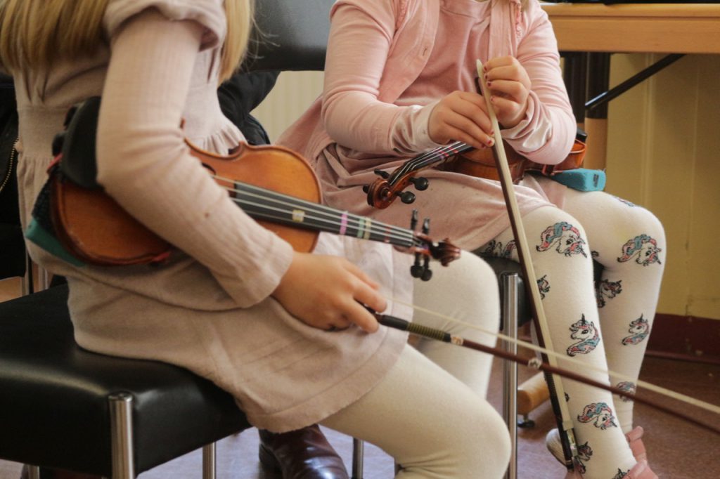 Zwei Kinder mit Geigen (Suzuki-Gruppenunterricht)